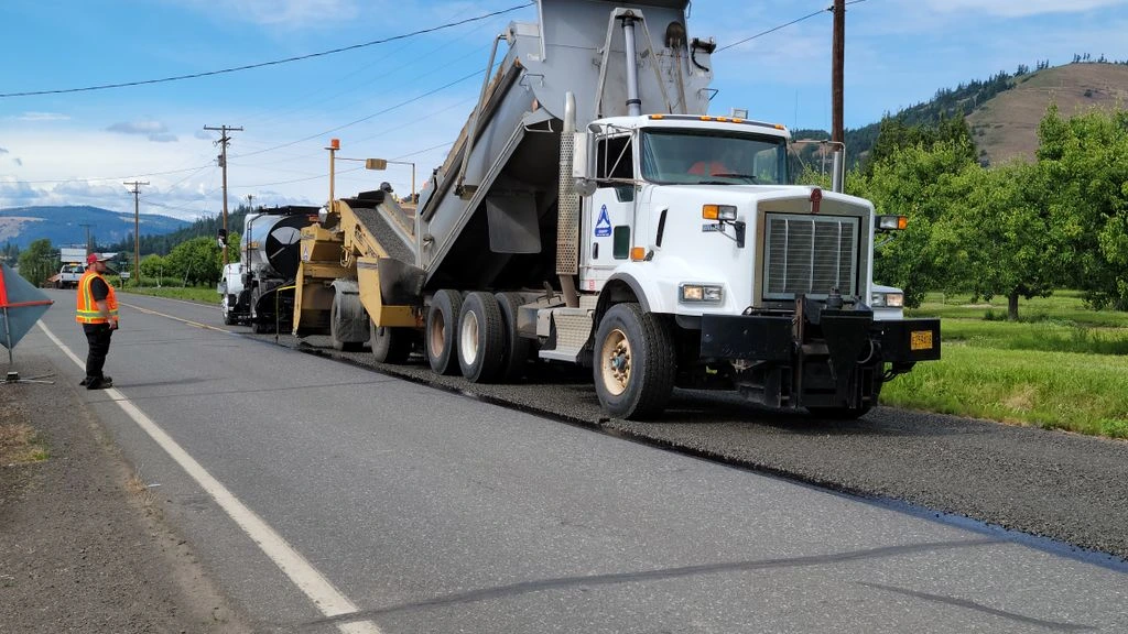 Greenville equipment depot with a row of late-model pavers and infrared patchers staged for deployment